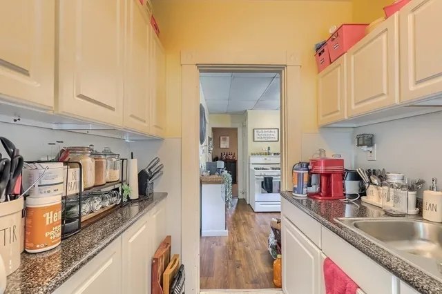 a kitchen with stainless steel appliances granite countertop a sink and cabinets