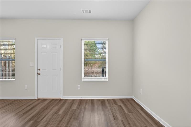 136 Brexley Drive Calhoun, GA 30701 - Photo 25 of 48 an empty room with wooden floor and windows
