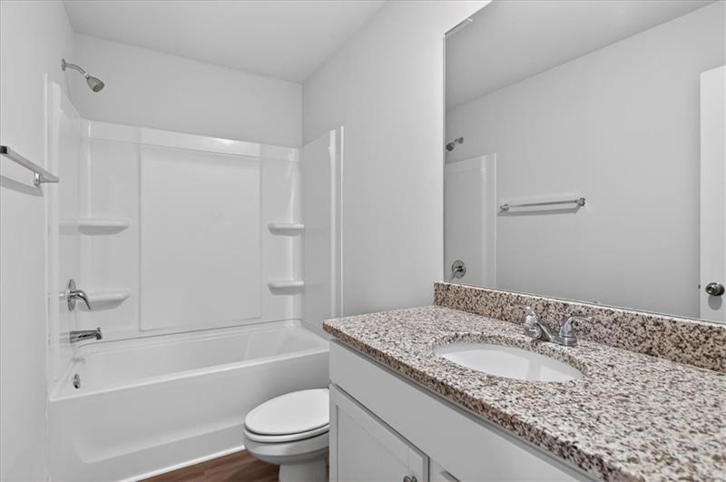 136 Brexley Drive Calhoun, GA 30701 - Photo 38 of 48 a bathroom with a granite countertop sink a toilet and shower