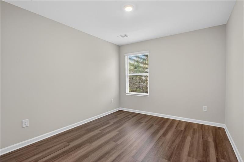 136 Brexley Drive Calhoun, GA 30701 - Photo 40 of 48 an empty room with wooden floor and windows