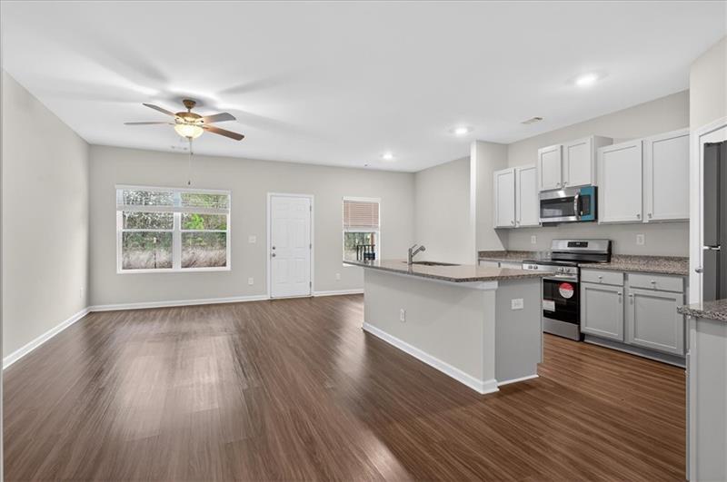 136 Brexley Drive Calhoun, GA 30701 - Photo 9 of 48 a kitchen with stainless steel appliances granite countertop a stove top oven a sink dishwasher and a microwave oven on the wooden floor