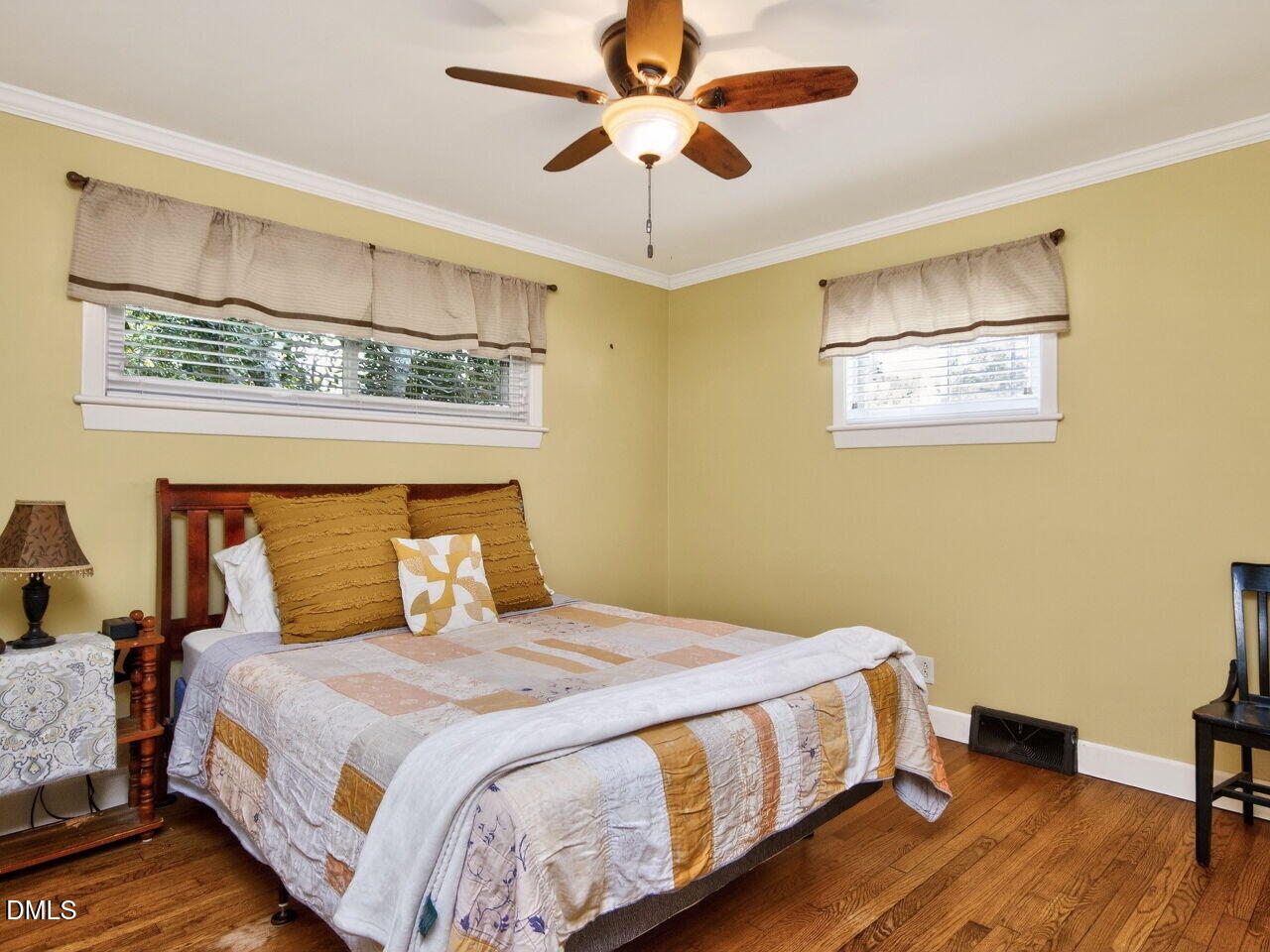 1123 Horseshoe Road Durham, NC 27703 - Photo 12 of 35 a bedroom with a bed and a chandelier