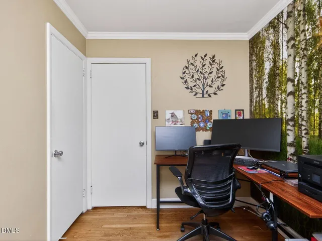 a view of a workspace with furniture and a window