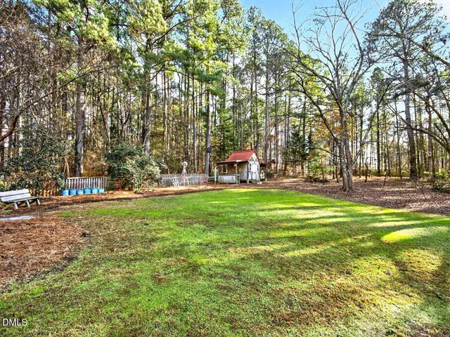 a view of yard with swimming pool and trees