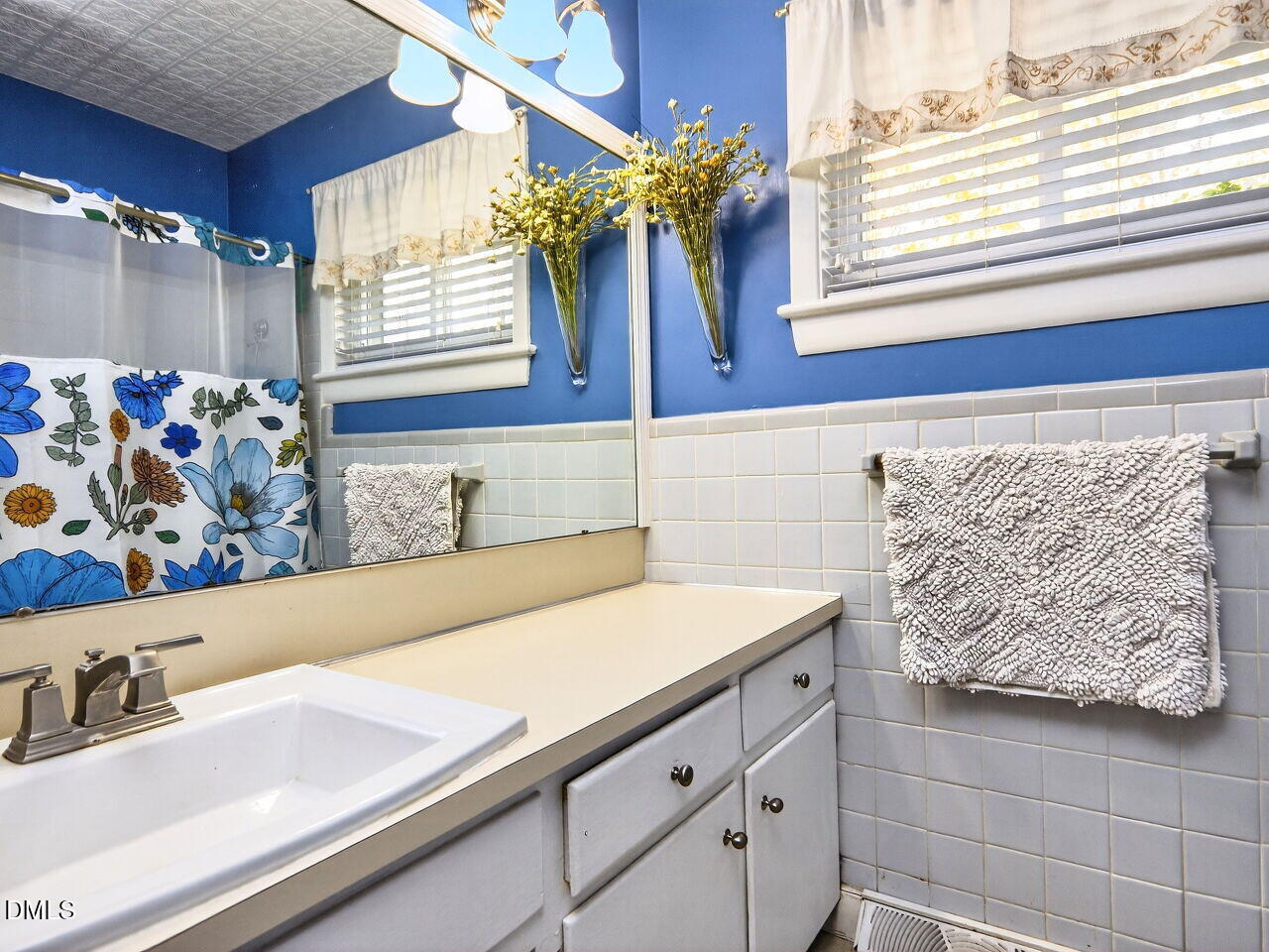 1123 Horseshoe Road Durham, NC 27703 - Photo 28 of 35 a bathroom with a sink and a mirror
