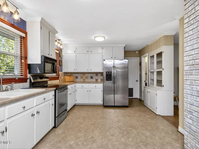 a kitchen with a refrigerator sink and microwave