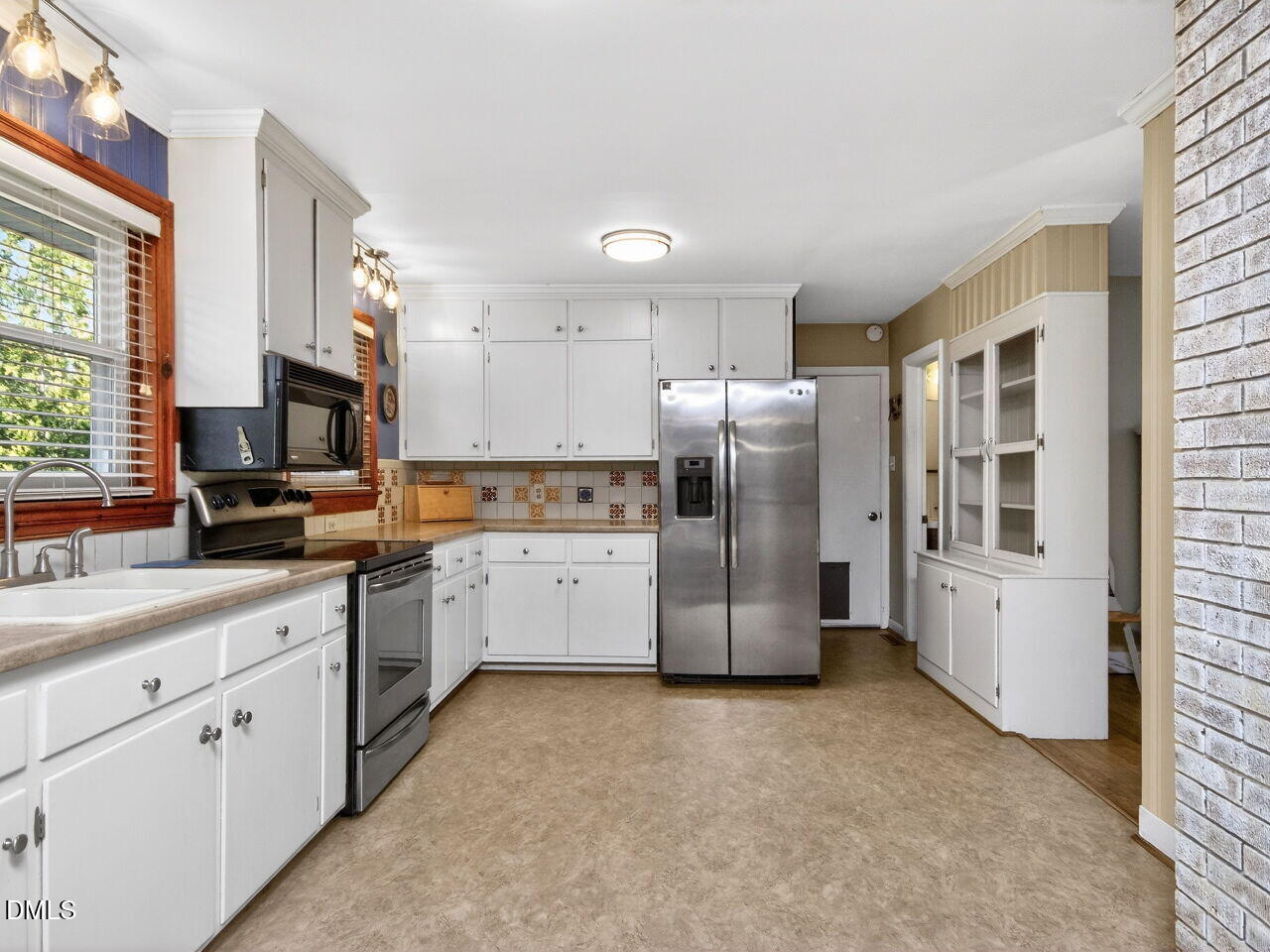 1123 Horseshoe Road Durham, NC 27703 - Photo 6 of 35 a kitchen with a refrigerator sink and microwave