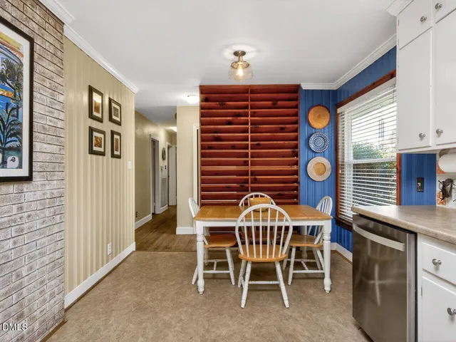 a view of a dinning room with a table and chairs