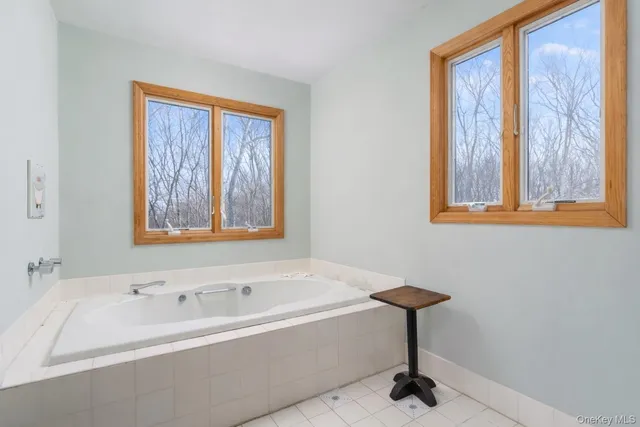 a bedroom with a large bed and a chandelier fan