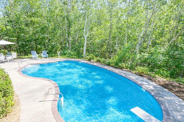 a kitchen with sink a counter and chairs