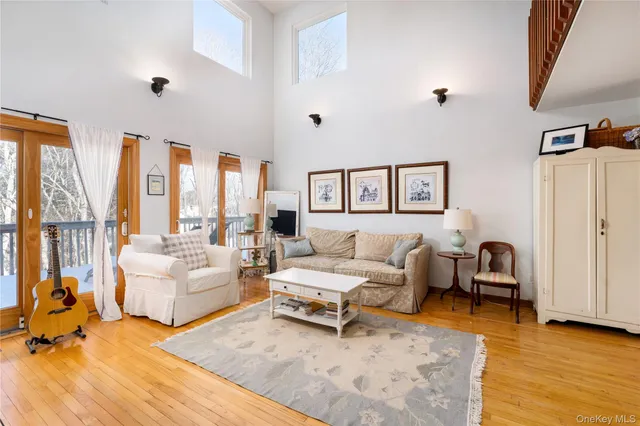 a spacious bedroom with a bed a table and a chandelier