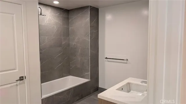 a bathroom with a shower and a sink