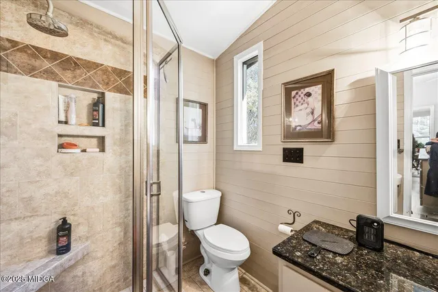 a bathroom with a toilet a sink and a shower