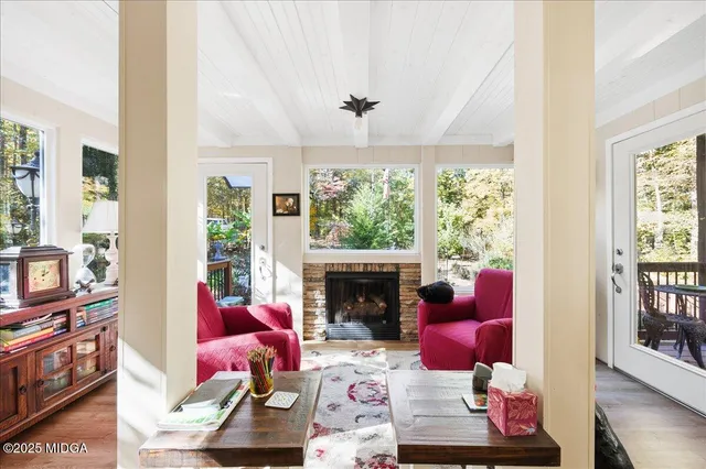 a living room with furniture fireplace and flat screen tv