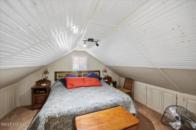 a bedroom with a bed and a couch