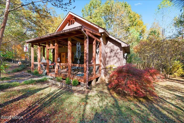 a view of a house with yard and sitting area