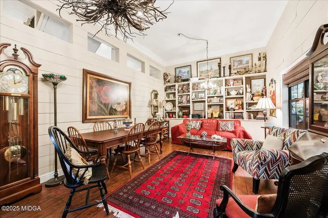 a living room with furniture a rug and a flat screen tv