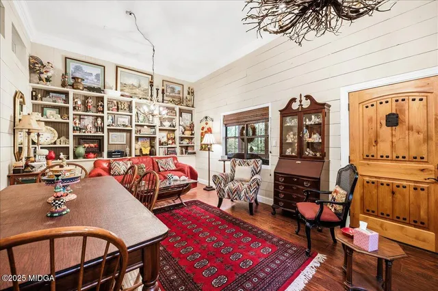 a living room with furniture a rug and a bookshelf