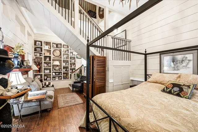 a bedroom with furniture and a large window