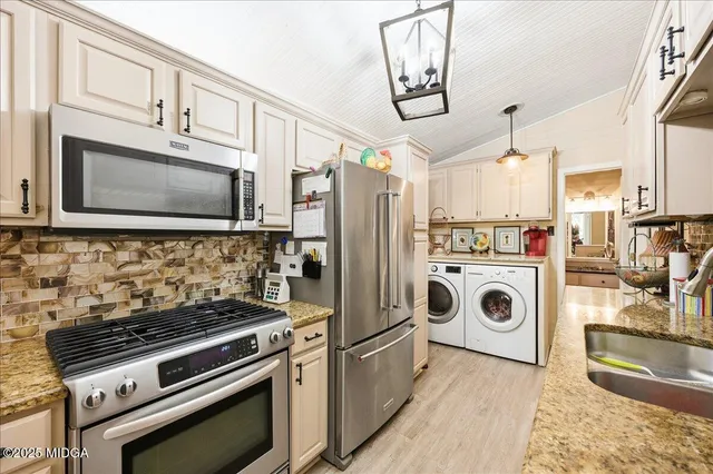a kitchen with a stove and a microwave