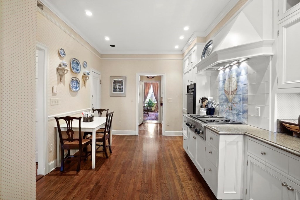 388 Beacon Street, Unit 3 Boston, MA 02116 - Photo 11 of 29 a large kitchen with stainless steel appliances a table and chairs in it