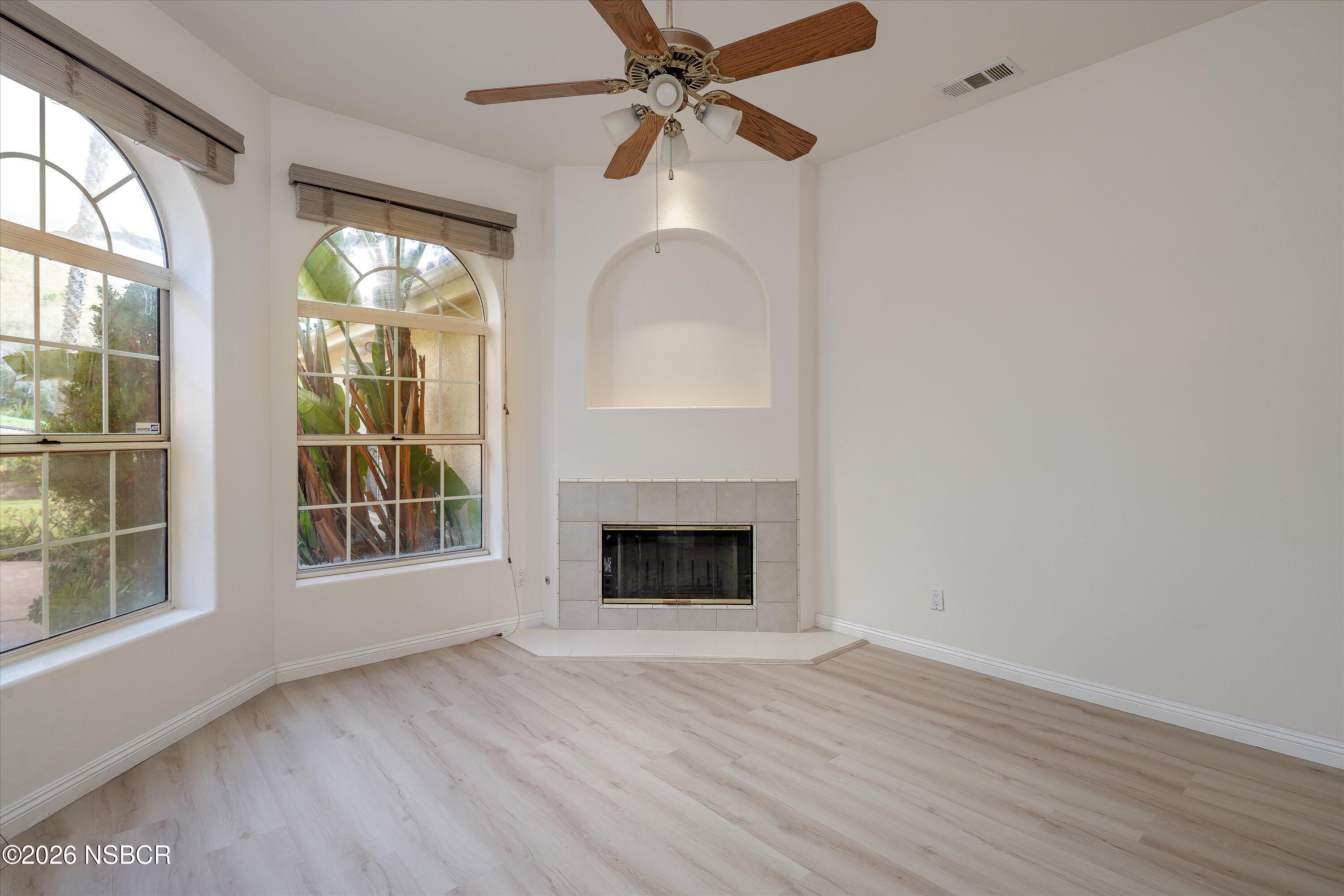 2655 Adobe Falls Road Lompoc, CA 93436 - Photo 31 of 51 an empty room with windows fireplace and fan