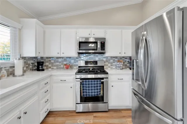 a kitchen with stainless steel appliances a refrigerator stove and sink