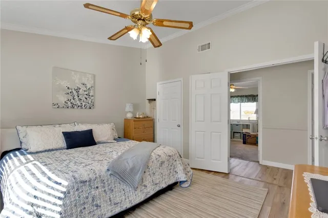 a bedroom with a large bed and a chandelier
