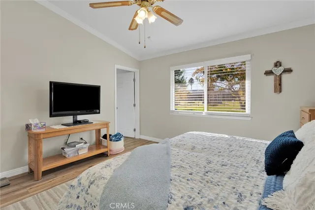 a bedroom with furniture and a flat screen tv