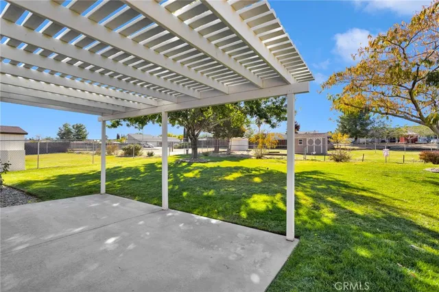 an aerial view of a house with a yard and mountain view