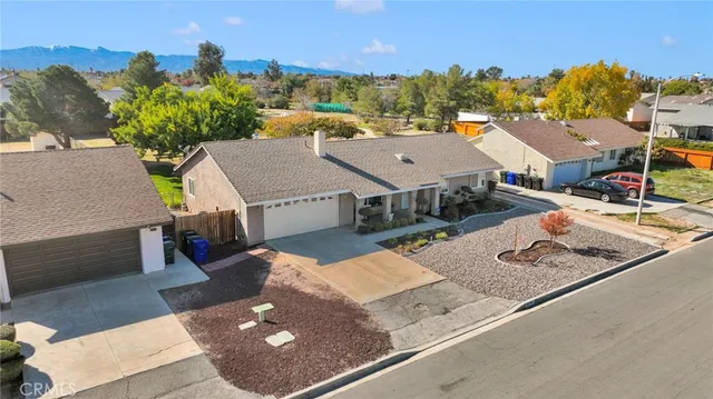an aerial view of a house with a yard and lake view