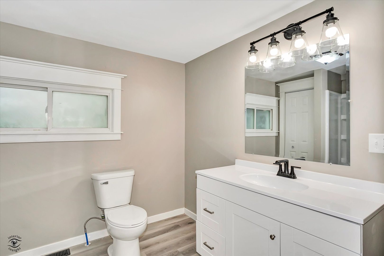 3032 West 9000N Road Manteno, IL 60950 - Photo 23 of 27 a bathroom with a sink a toilet and a mirror