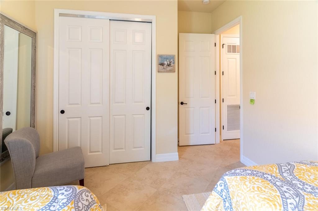 9372 Vercelli Court Naples, FL 34113 - Photo 26 of 50 Tiled bedroom featuring a closet