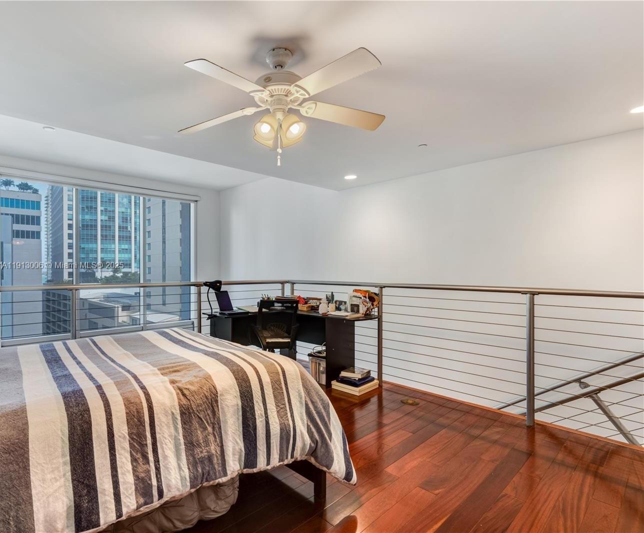 1060 Brickell Avenue, Unit 1007 Miami, FL 33131 - Photo 4 of 14 a bedroom with a bed and wooden floor
