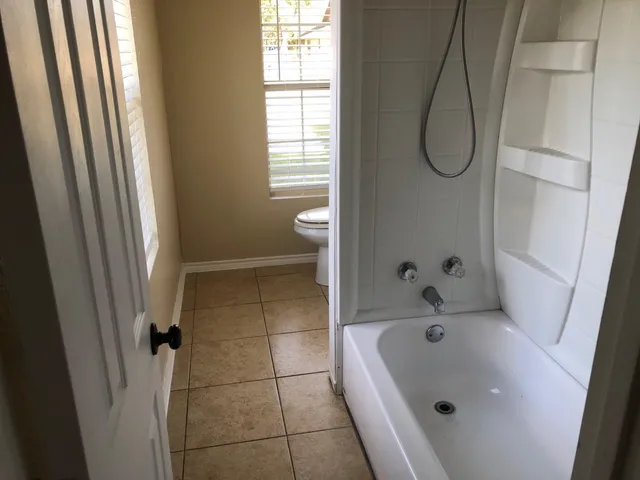 a bathroom with a tub a sink and a shower