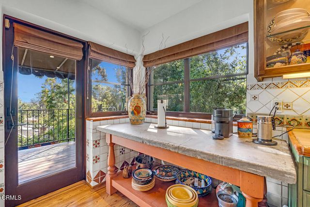 a view of a chairs and table in the balcony