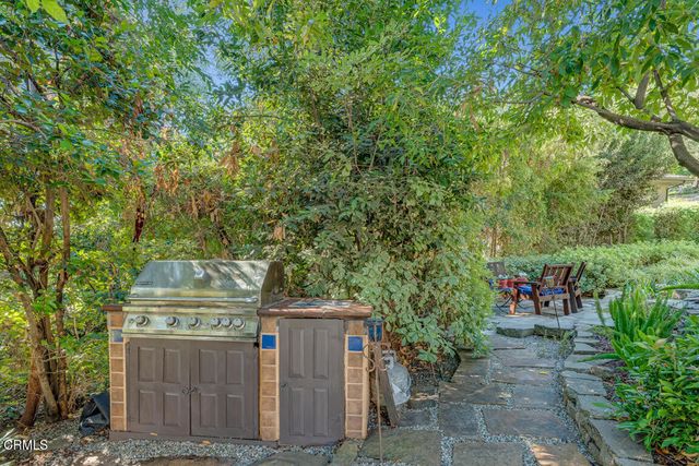 a kitchen with stainless steel appliances granite countertop a sink and a refrigerator
