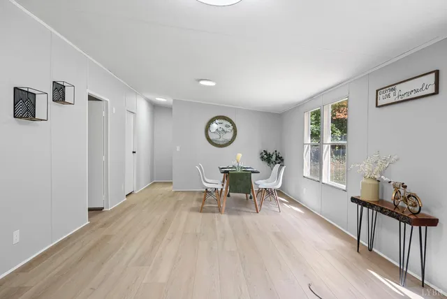 a view of a work space with furniture and wooden floor