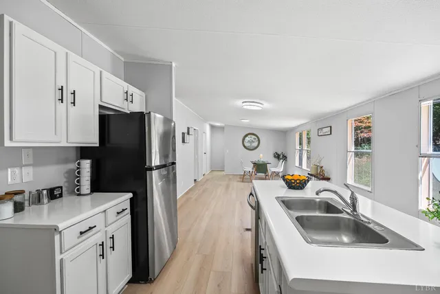 a kitchen with a sink a refrigerator and a sink