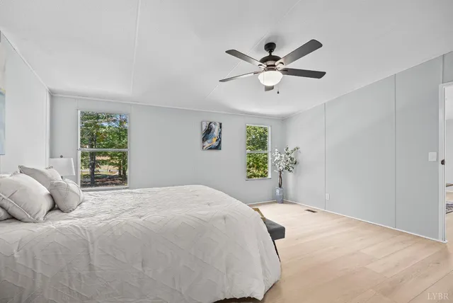 a bedroom with a large bed and a window