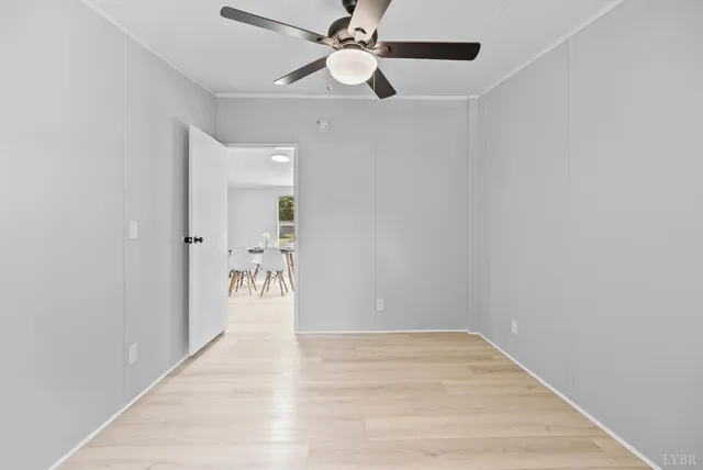 an empty room with fan and a ceiling fan