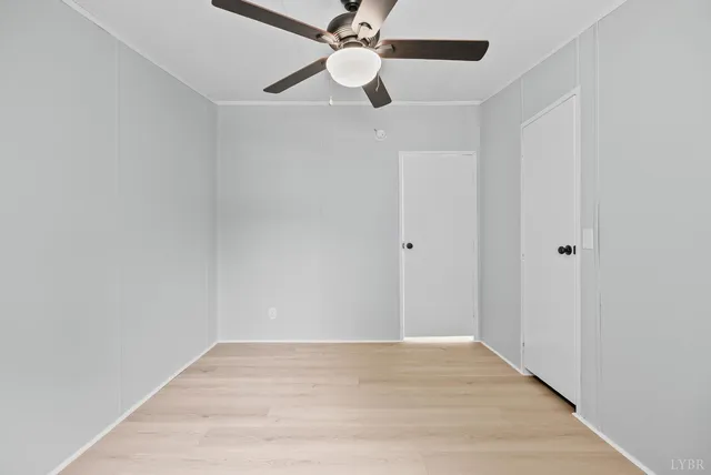 a view of empty room with wooden floor