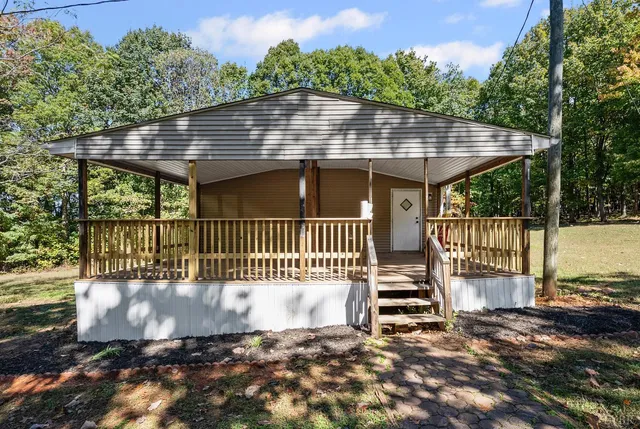 a view of a house with a wooden deck