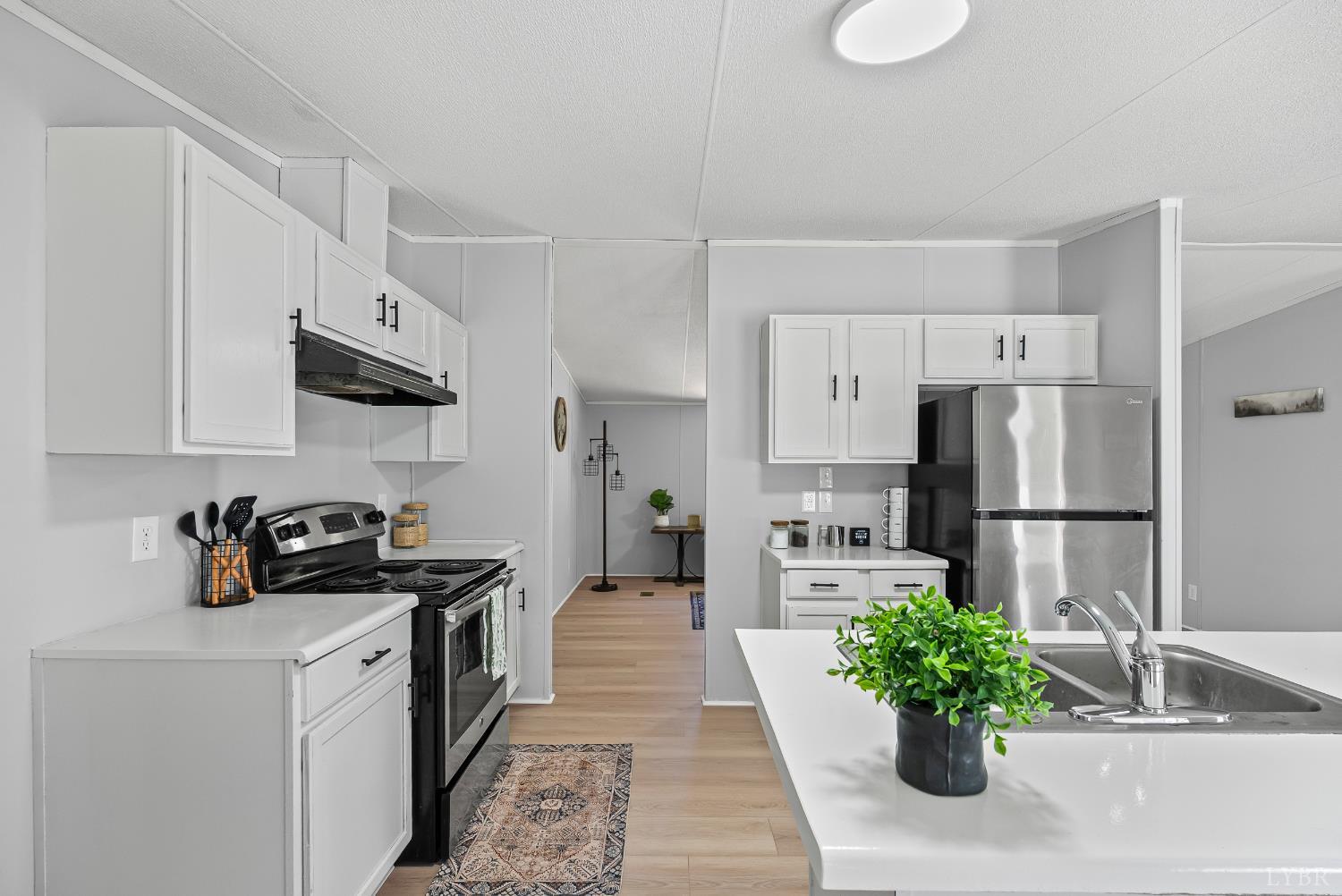 509 Oak Hill Road Prospect, VA 23960 - Photo 5 of 41 a kitchen with white cabinets and stainless steel appliances