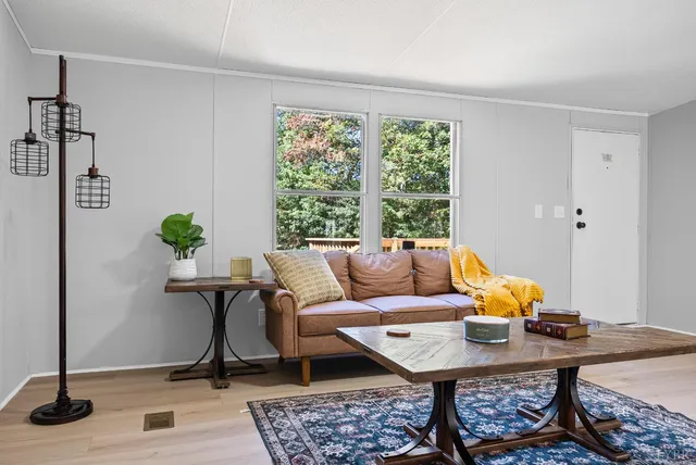 a living room with furniture and wooden floor