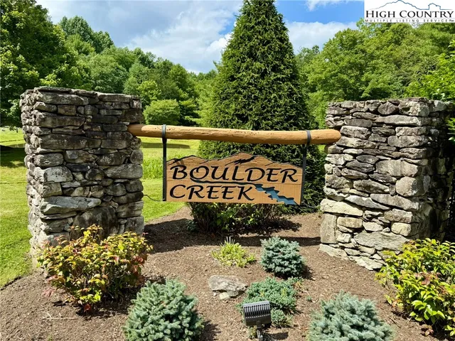 a sign that is sitting in front of flowers