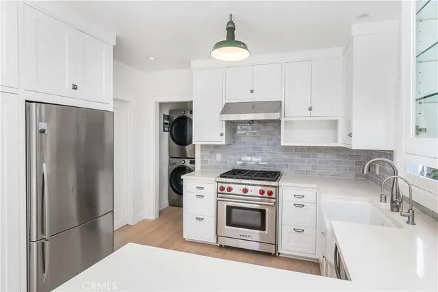 a kitchen with a stove a refrigerator and a sink