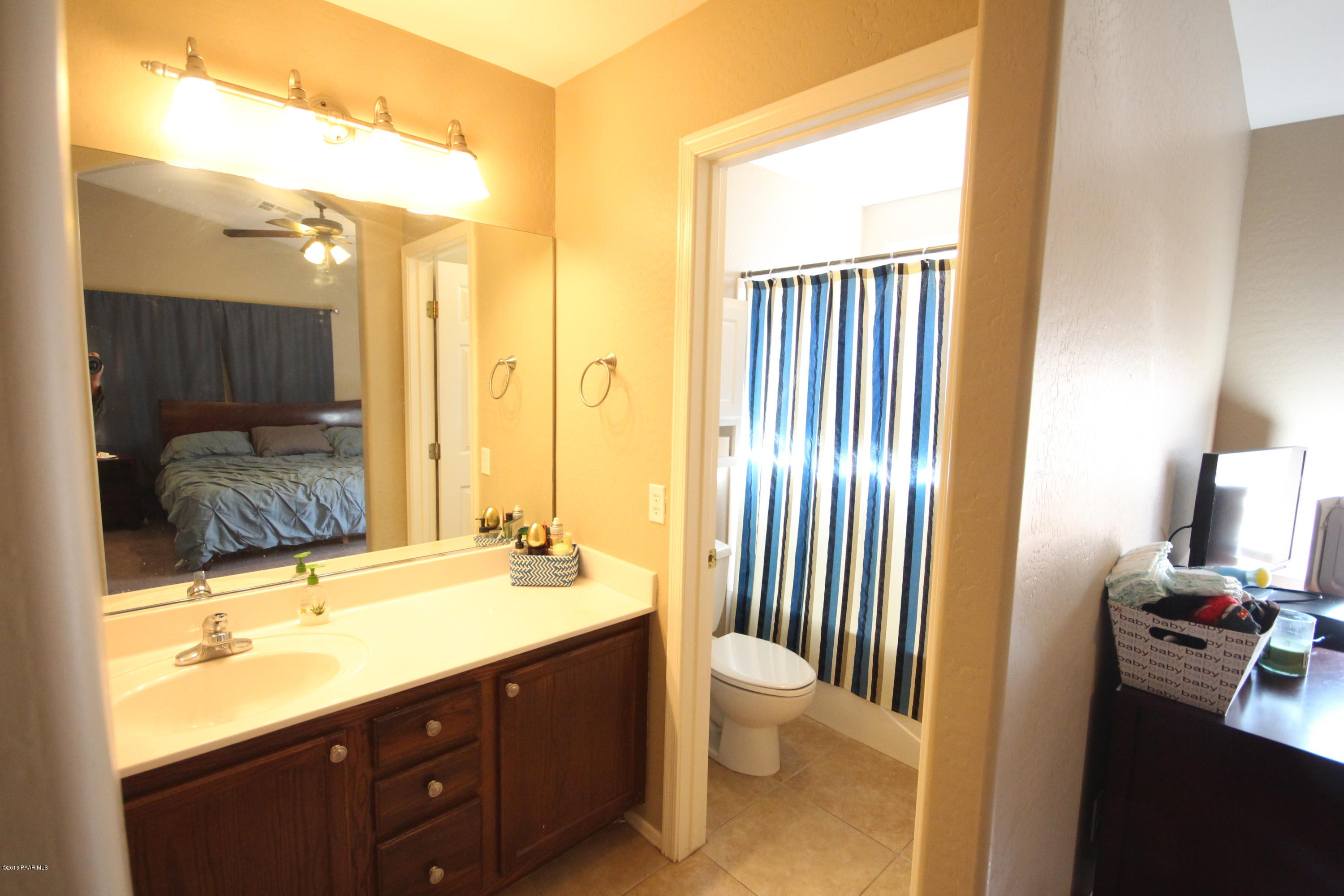 7449 East Plateau Ridge Road Prescott Valley, AZ 86315 - Photo 11 of 17 a bathroom with a double vanity sink toilet and shower