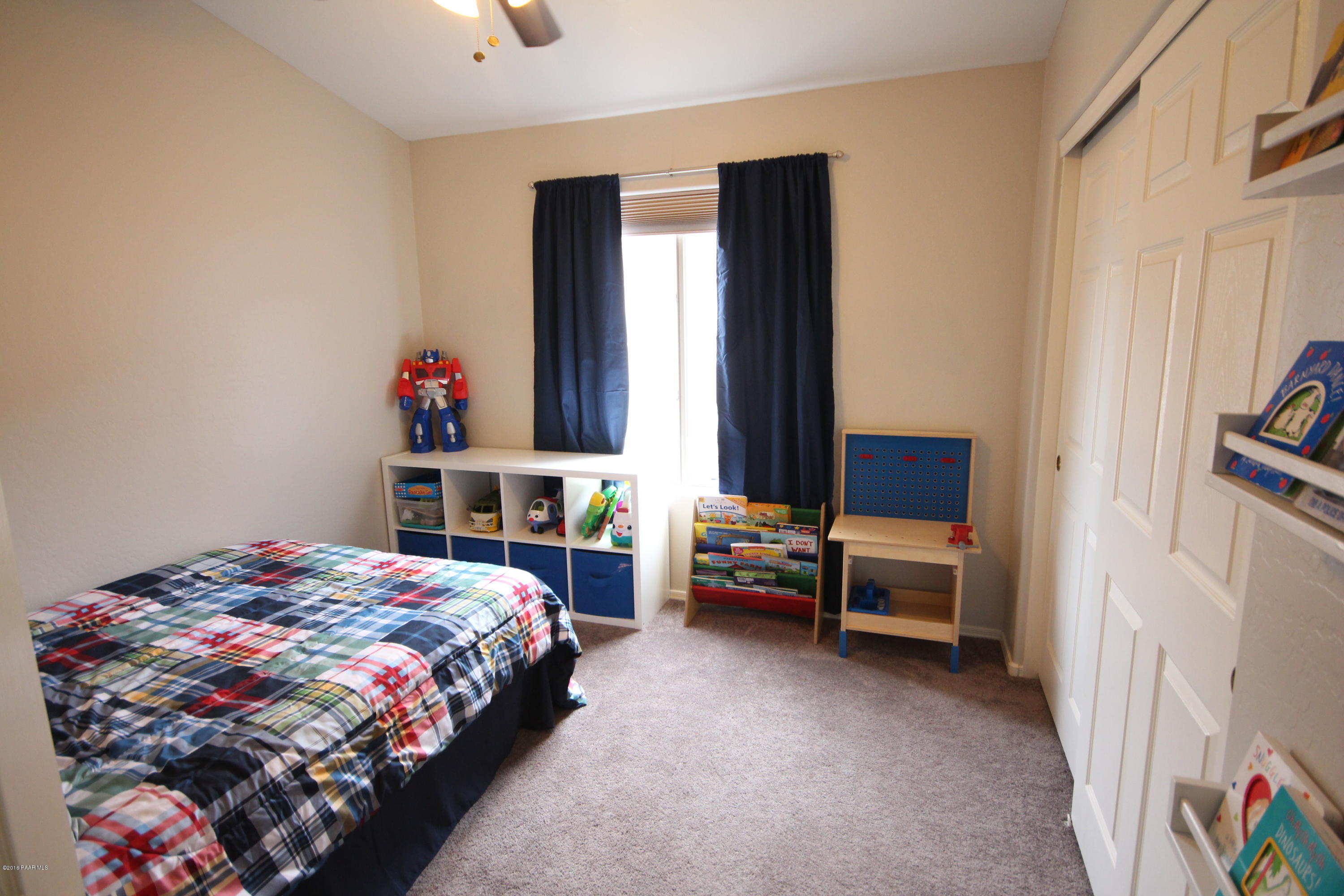 7449 East Plateau Ridge Road Prescott Valley, AZ 86315 - Photo 12 of 17 a bedroom with a bed and a window