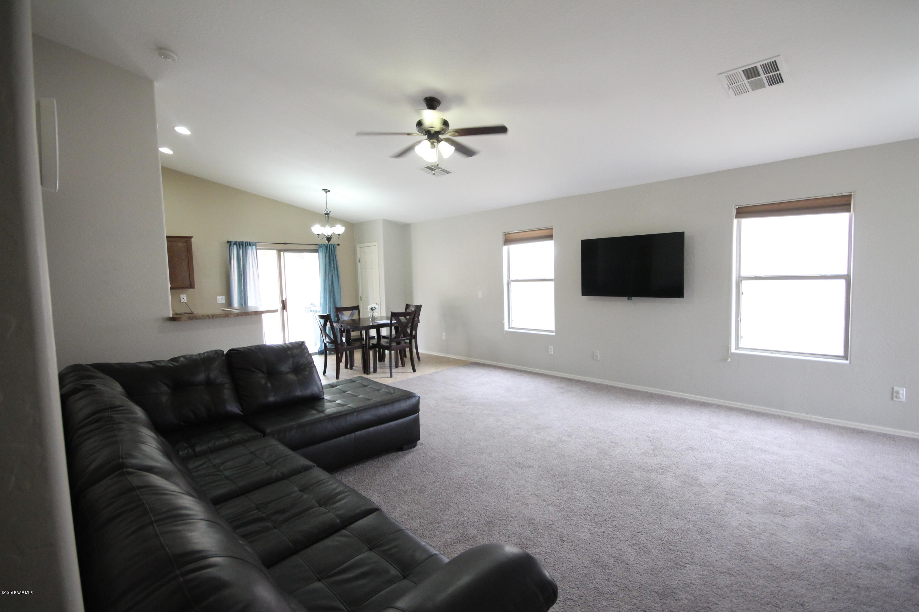 7449 East Plateau Ridge Road Prescott Valley, AZ 86315 - Photo 4 of 17 a living room with furniture and a flat screen tv